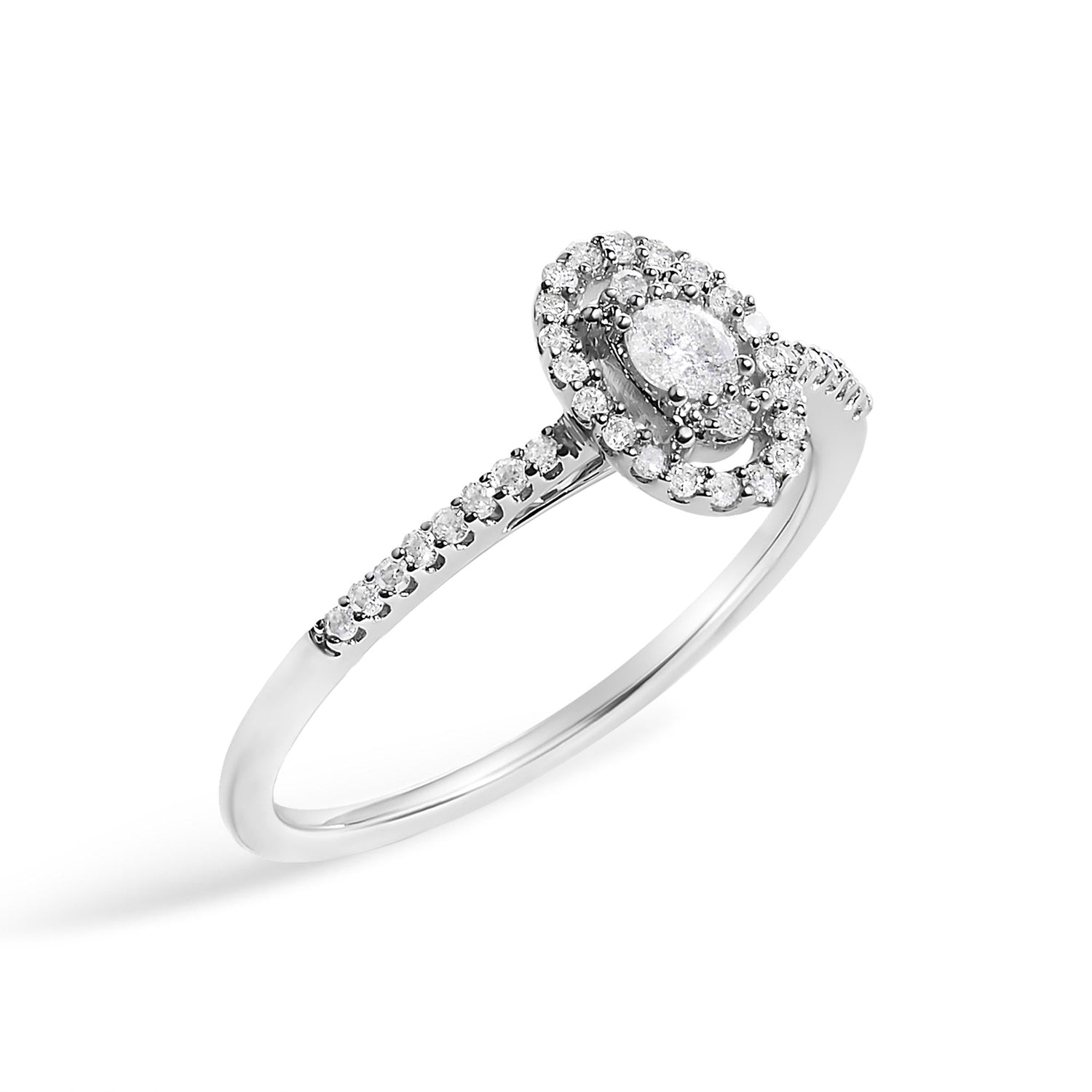 Silver ring with an oval diamond center, surrounded by smaller diamonds on a thin band.