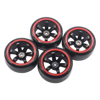 Four black wheels with red rims arranged in a cluster on a white background.