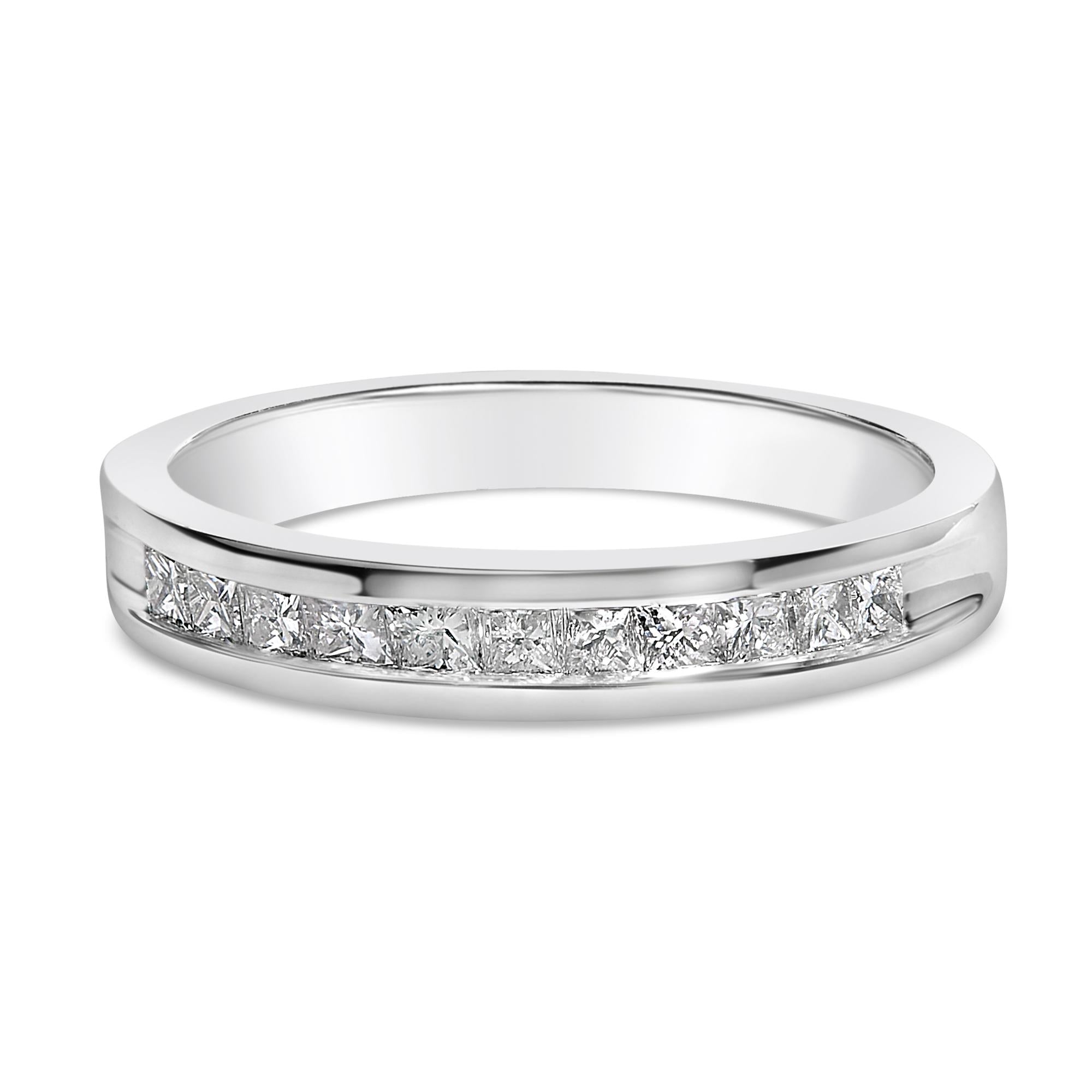 Silver ring with embedded square-cut diamonds in a channel setting on a white background.