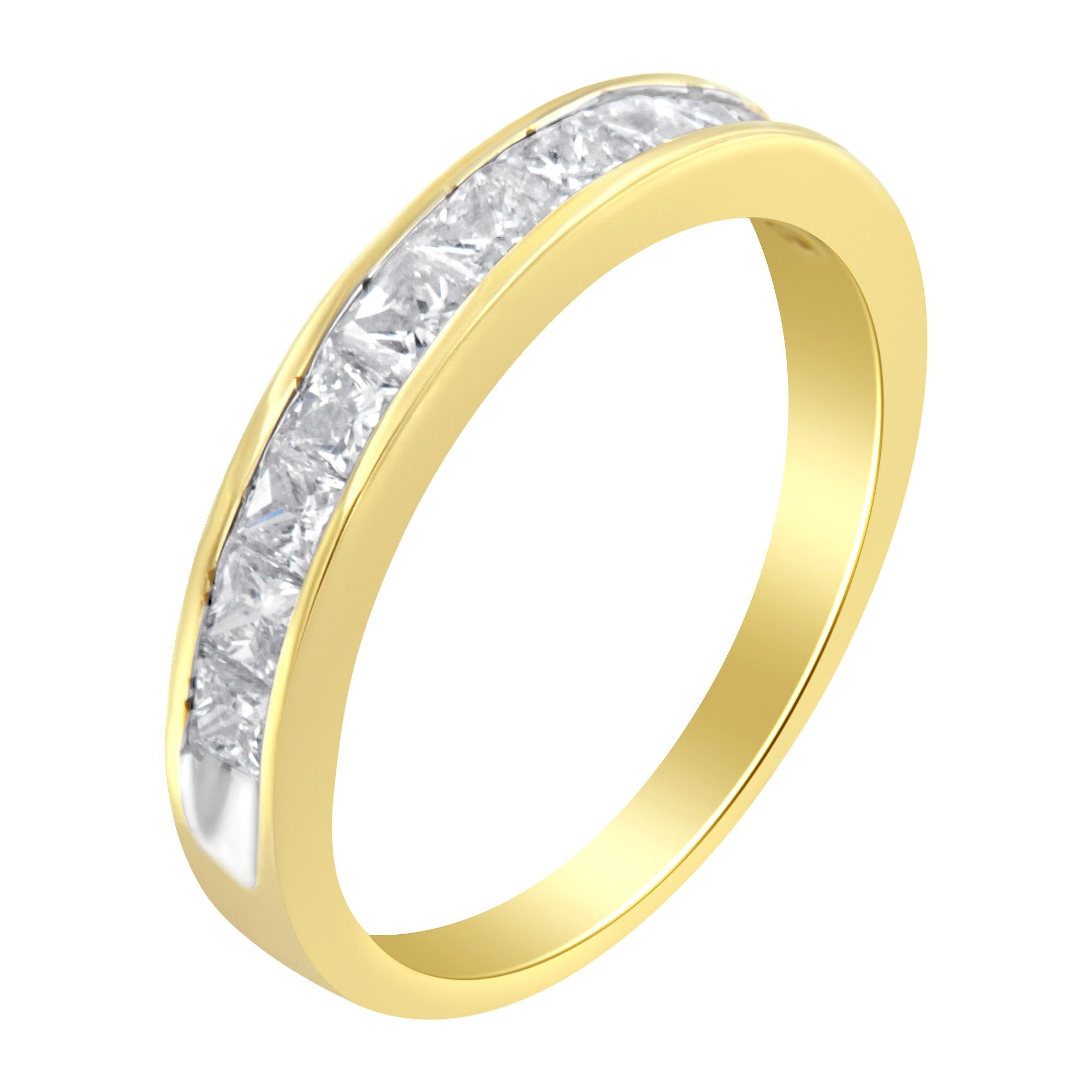 Gold ring with a row of clear, sparkling gemstones embedded along the top surface.