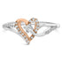 Silver and rose gold heart-shaped ring with sparkling diamonds and a central gemstone.