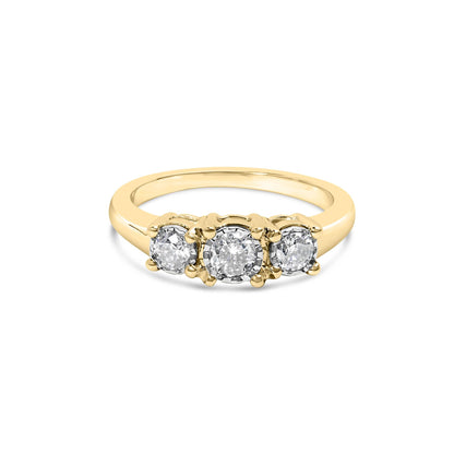 Gold ring with three round diamonds set in a row; simple band design.