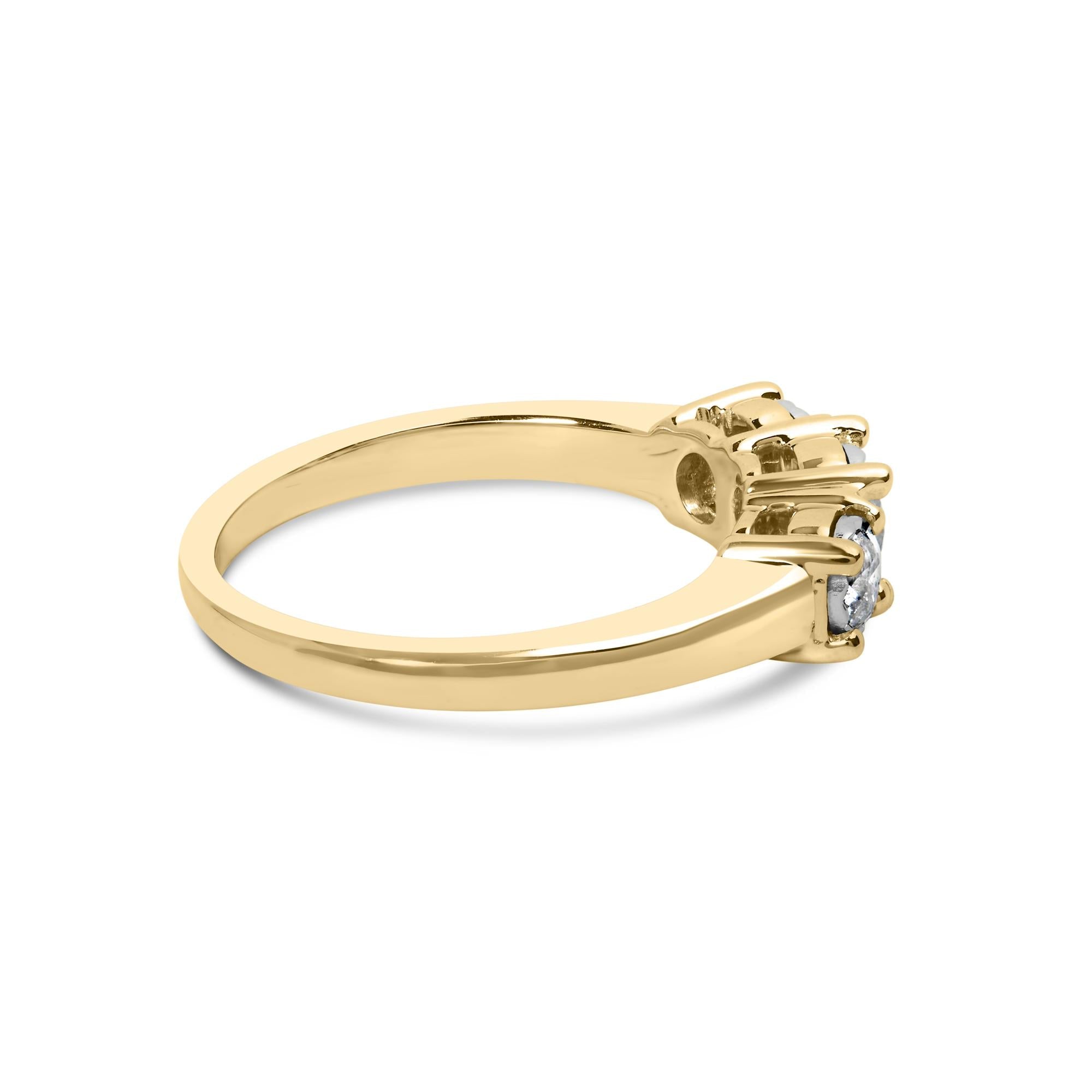 Gold ring with three round diamonds in prong settings, shown from the side view.