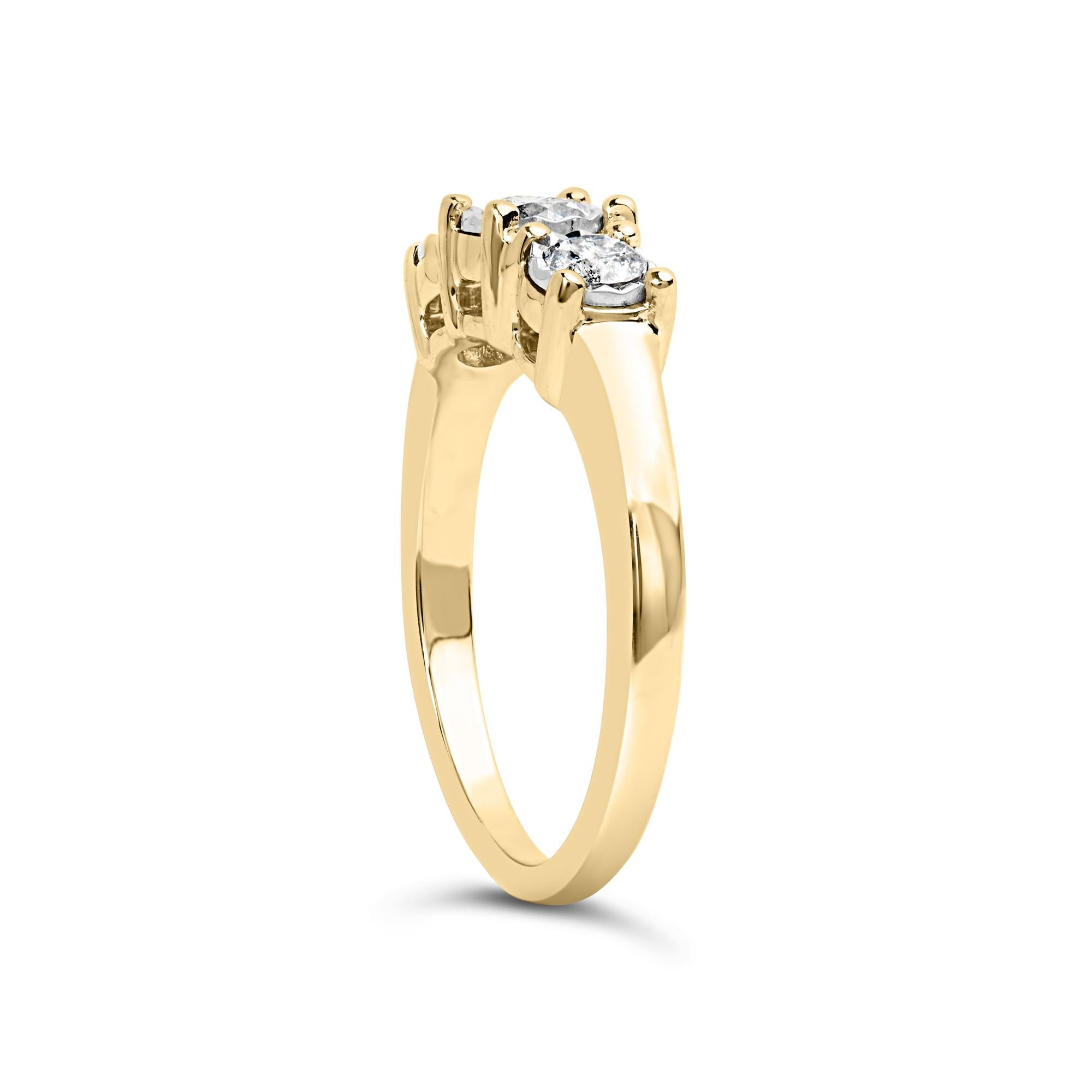 Gold ring with three sparkling diamonds in prong settings, shown on a white background.