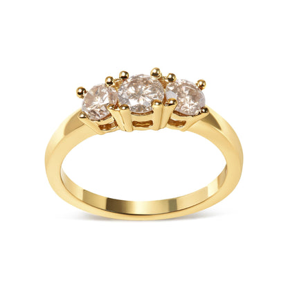 Gold ring with three round diamonds set in prongs, elegant and reflective design.