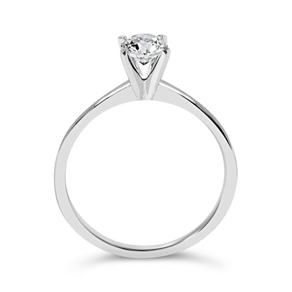Silver ring with a single round diamond in a prong setting, simple and elegant design.