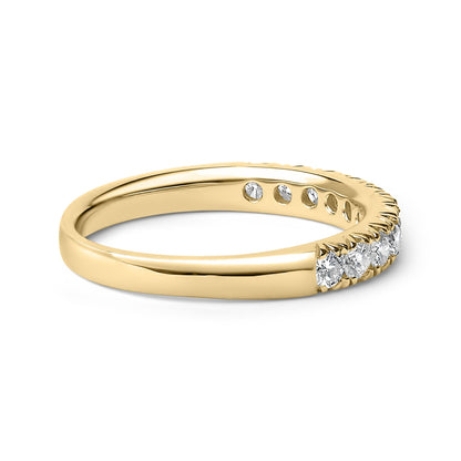 Gold ring with a row of sparkling diamonds set on the top half, glossy finish.