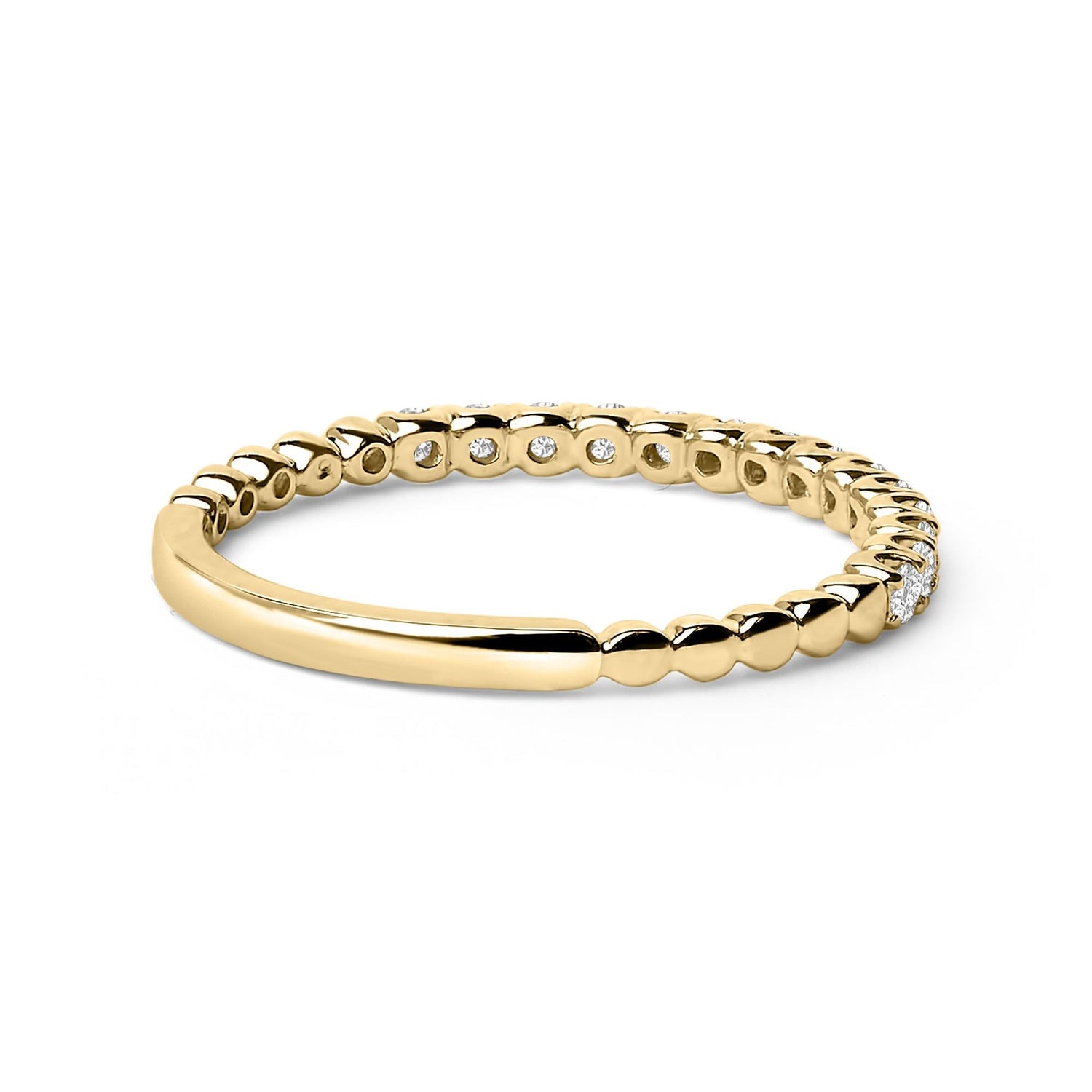 Gold ring with a beaded texture and embedded diamonds, reflecting light on a white background.