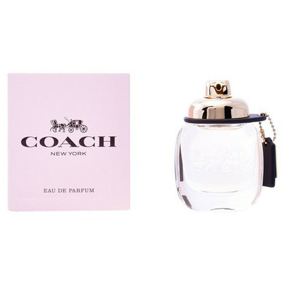 Pink box and clear perfume bottle with a gold cap and black tag.