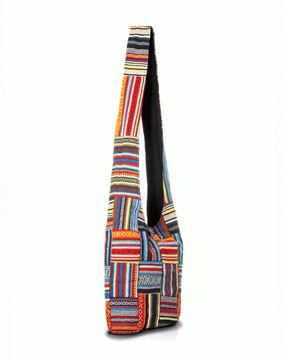Colorful woven shoulder bag with geometric patterns in red, blue, yellow, and green stripes.