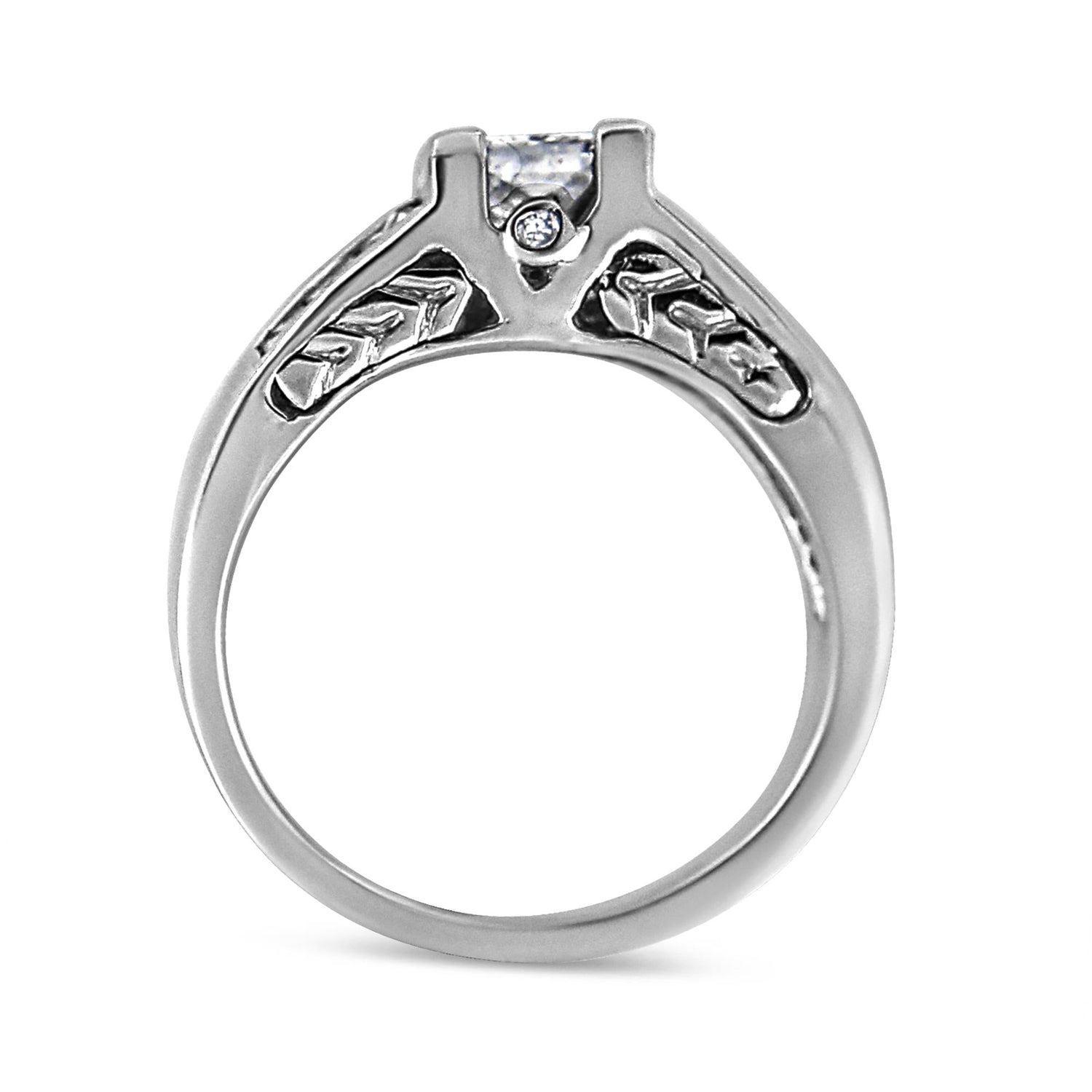 Silver ring with intricate leaf and star patterns on the band, featuring a central diamond.