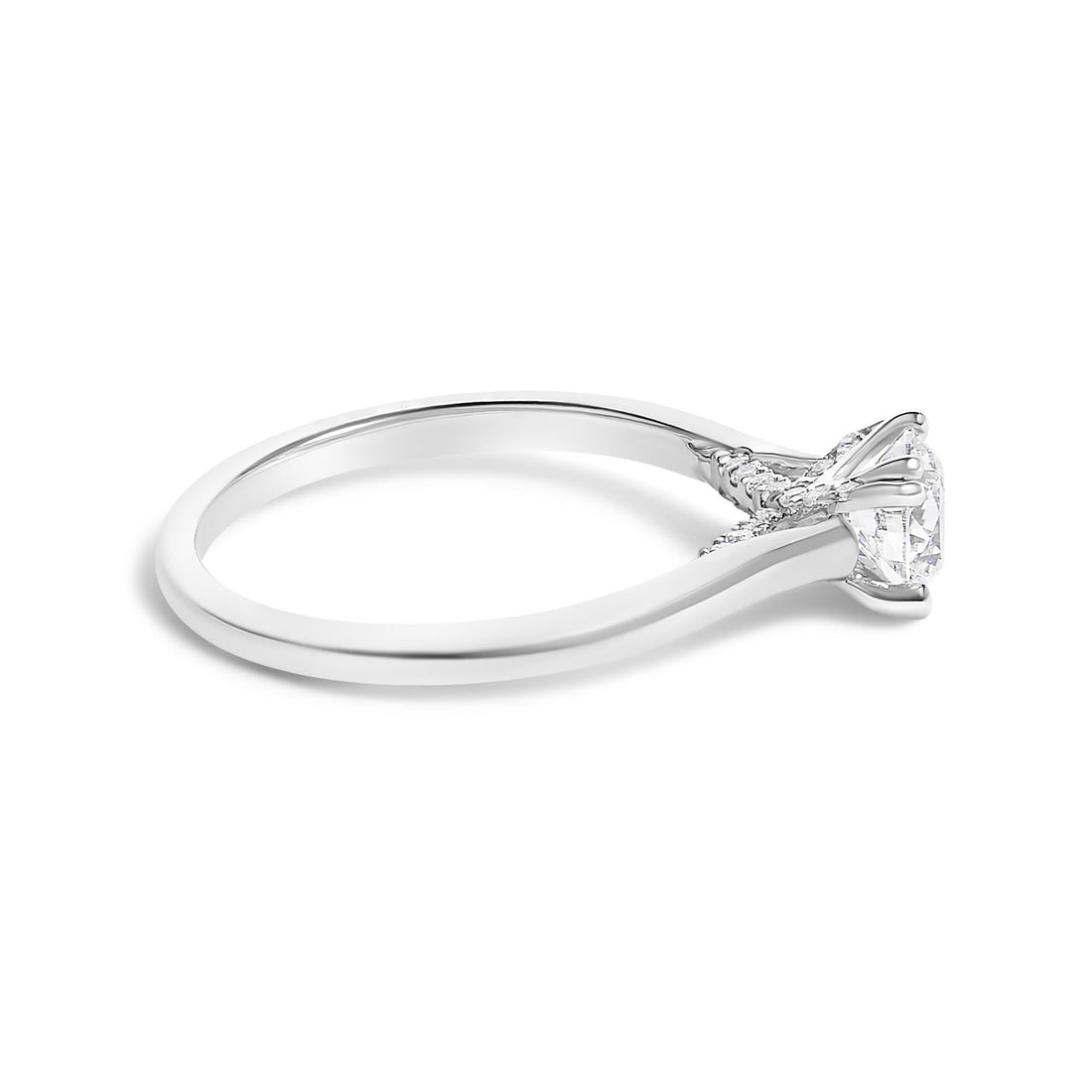 Silver ring with a single prong-set diamond, delicate band, and side view on a white background.