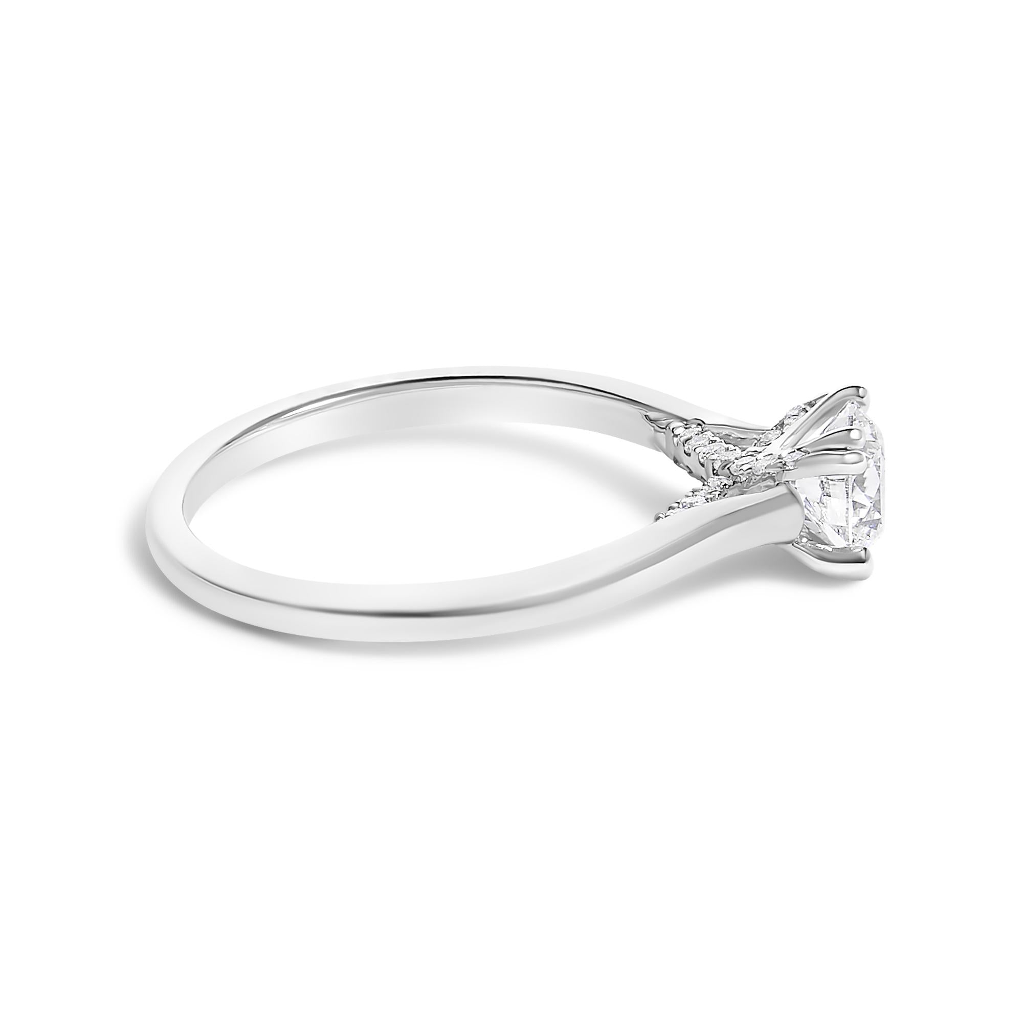 Silver ring with a single prong-set diamond, delicate band, and side view on a white background.