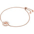 Rose gold bracelet with circular crystal pendant and adjustable chain, featuring small charm details.