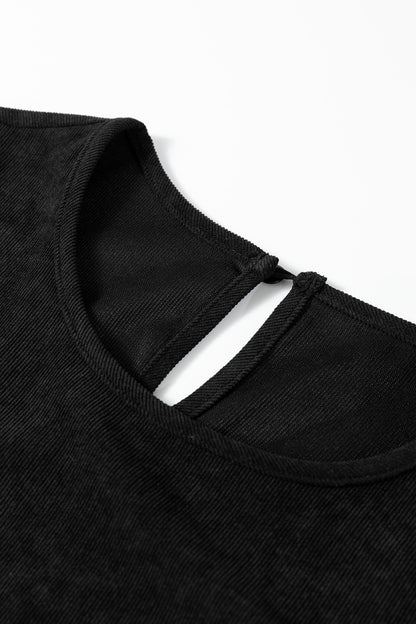 Black ribbed fabric top with a round neckline and a keyhole back button closure.