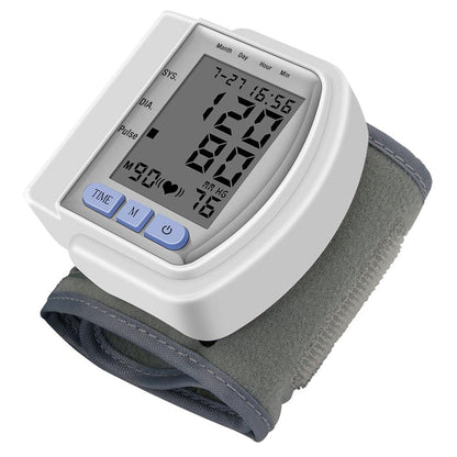 Digital wrist blood pressure monitor with grey cuff, large display, and blue buttons.