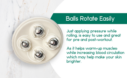 Beige massage roller with four metal balls, text on the side, marble background.
