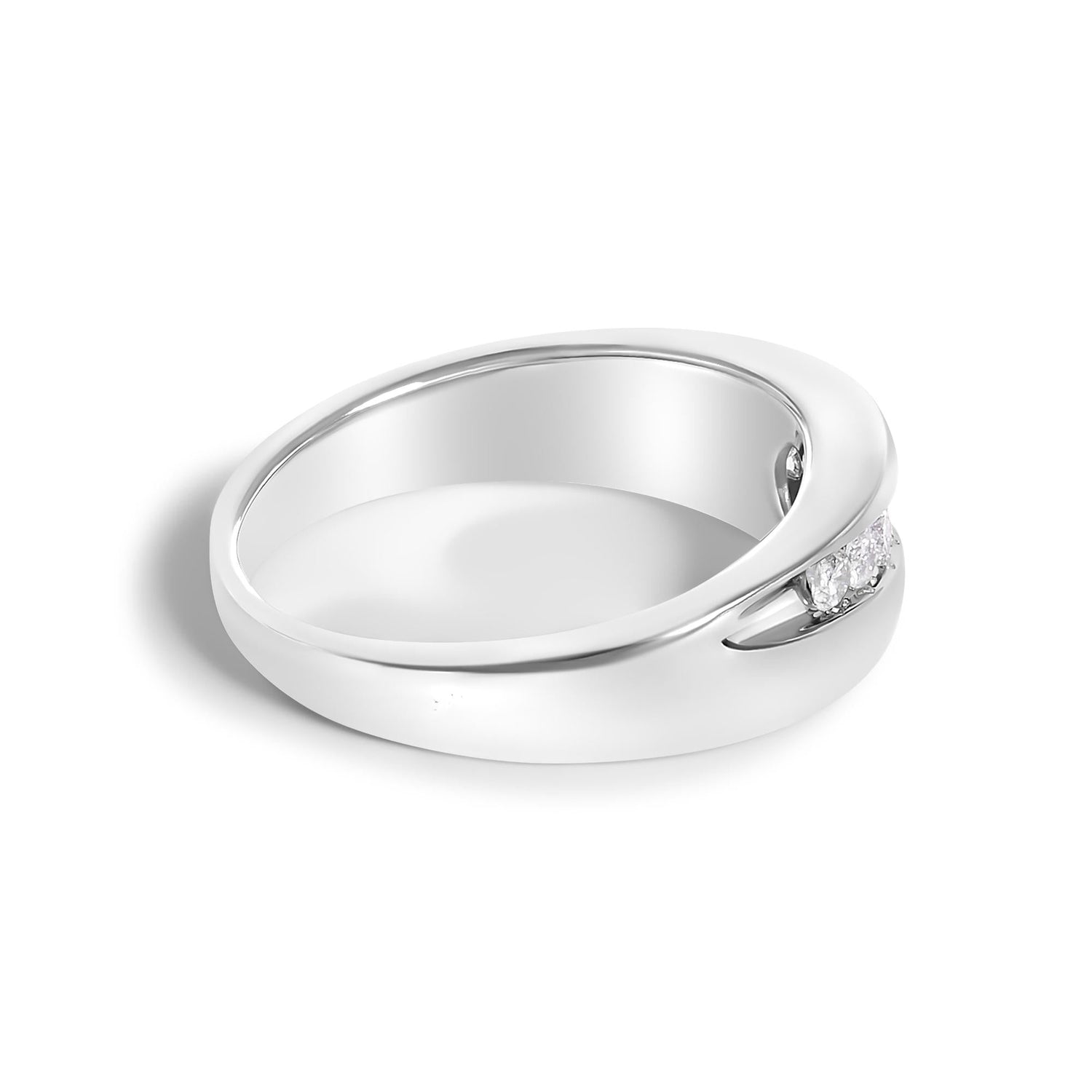 Silver ring with a smooth band and small diamonds set in a gap, casting a soft shadow.