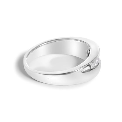 Silver ring with a smooth band and small diamonds set in a gap, casting a soft shadow.