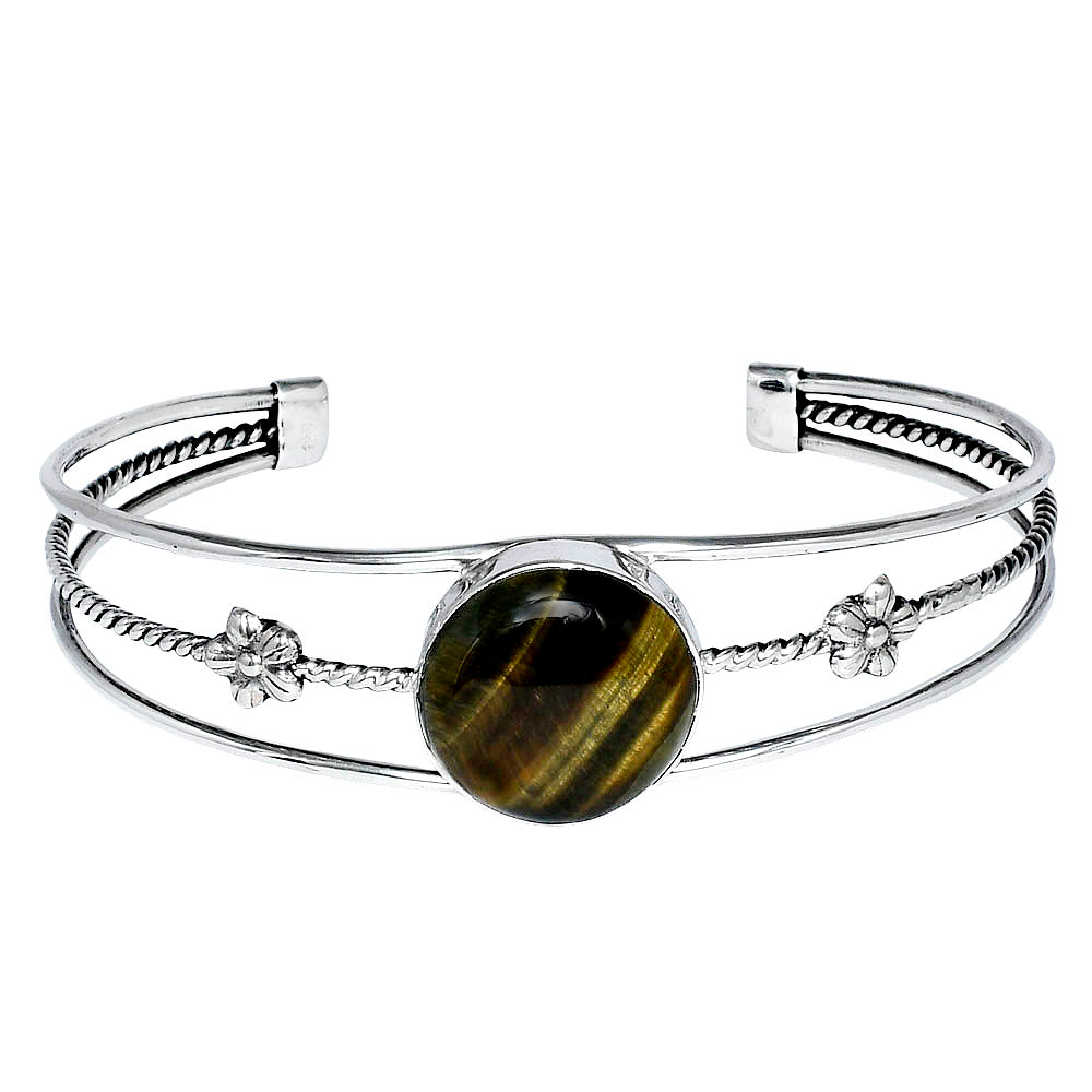 Silver cuff bracelet with a round brown gemstone and floral designs on a woven band.