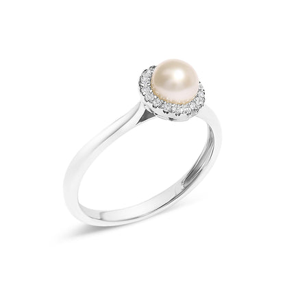 Silver ring with a single pearl, encircled by small diamonds, on a plain white background.
