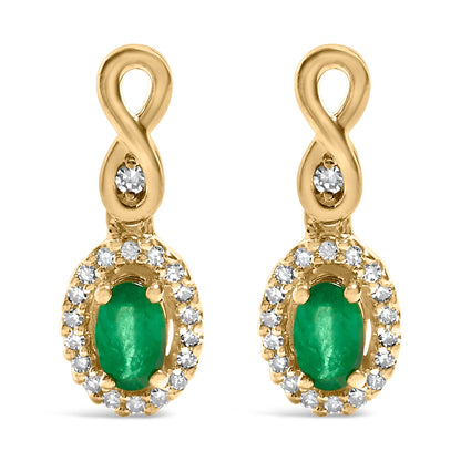Gold earrings with green oval stones, diamond accents, and looped top design.