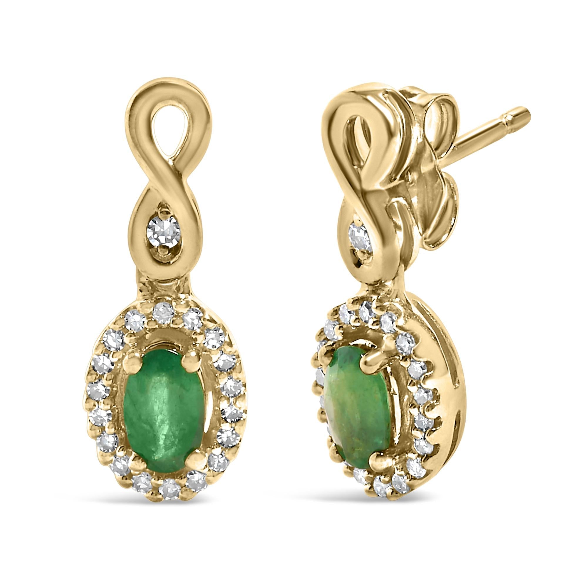 Gold infinity earrings with green oval stones and small white crystals.