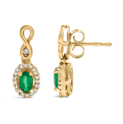 Gold earrings with green oval gem and halo of small white stones, featuring an infinity loop design.