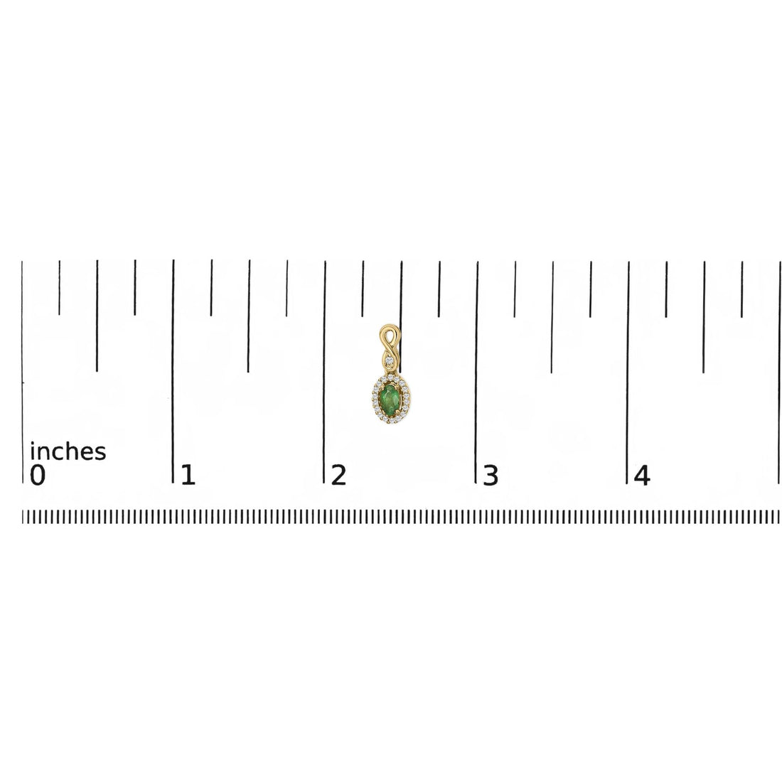Small gold pendant with green gem, surrounded by clear stones, next to a ruler showing about 2 inches.