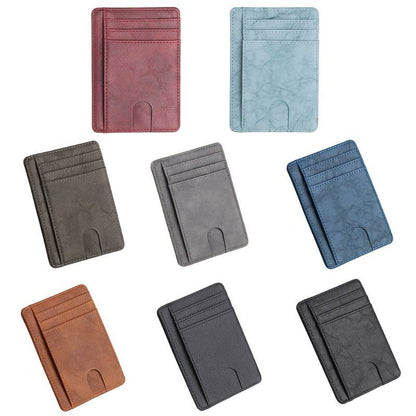 Seven leather cardholders in red, light blue, dark blue, brown, black, gray, and dark gray.