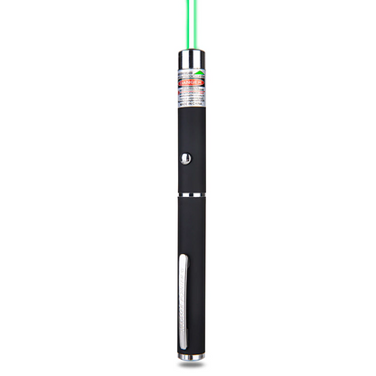 Black laser pointer with chrome accents, emitting a green beam from the top, red warning label visible.