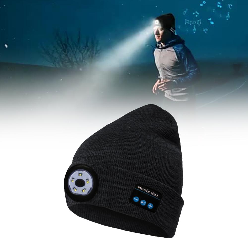 Black beanie with built-in LED light and control buttons, worn by a runner at night.