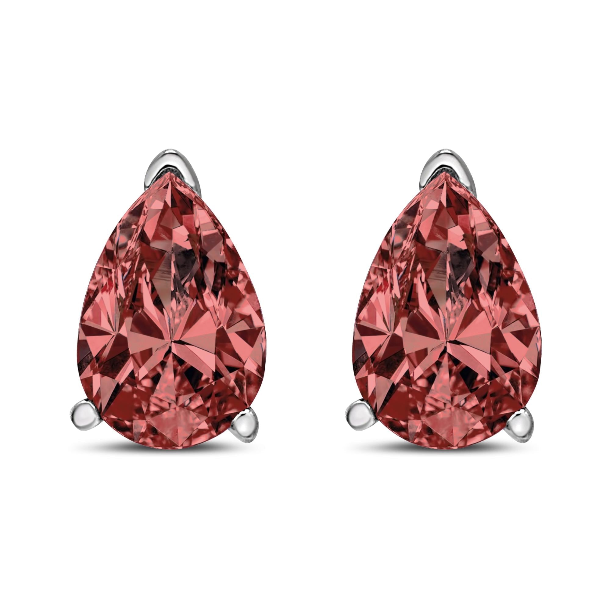 Two teardrop-shaped pink gemstones with silver prongs on a white background.