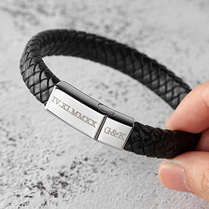 A black braided leather bracelet with a silver clasp engraved with Roman numerals and initials.