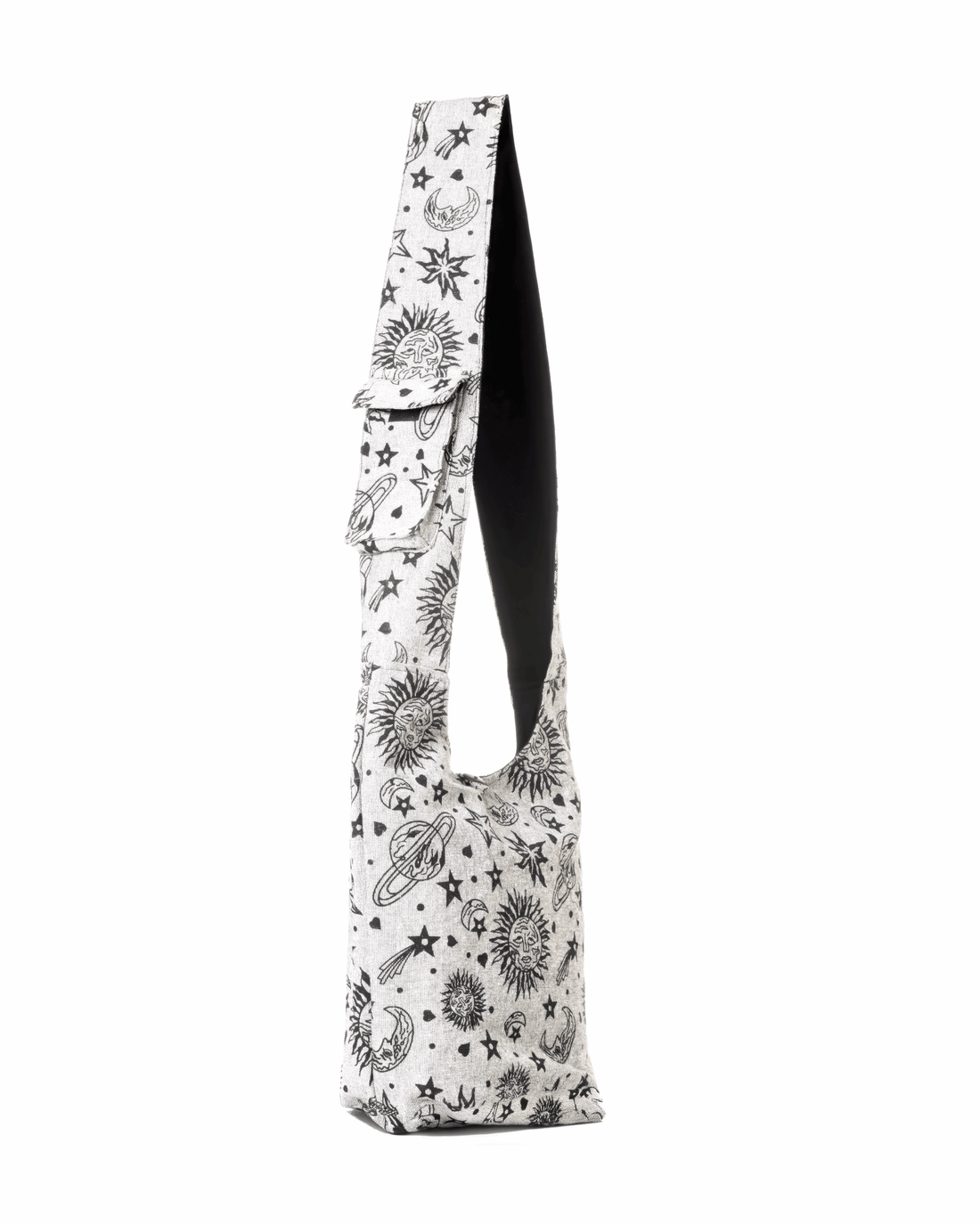 Beige sling bag with a cosmic print of stars, planets, and moons; black interior lining.