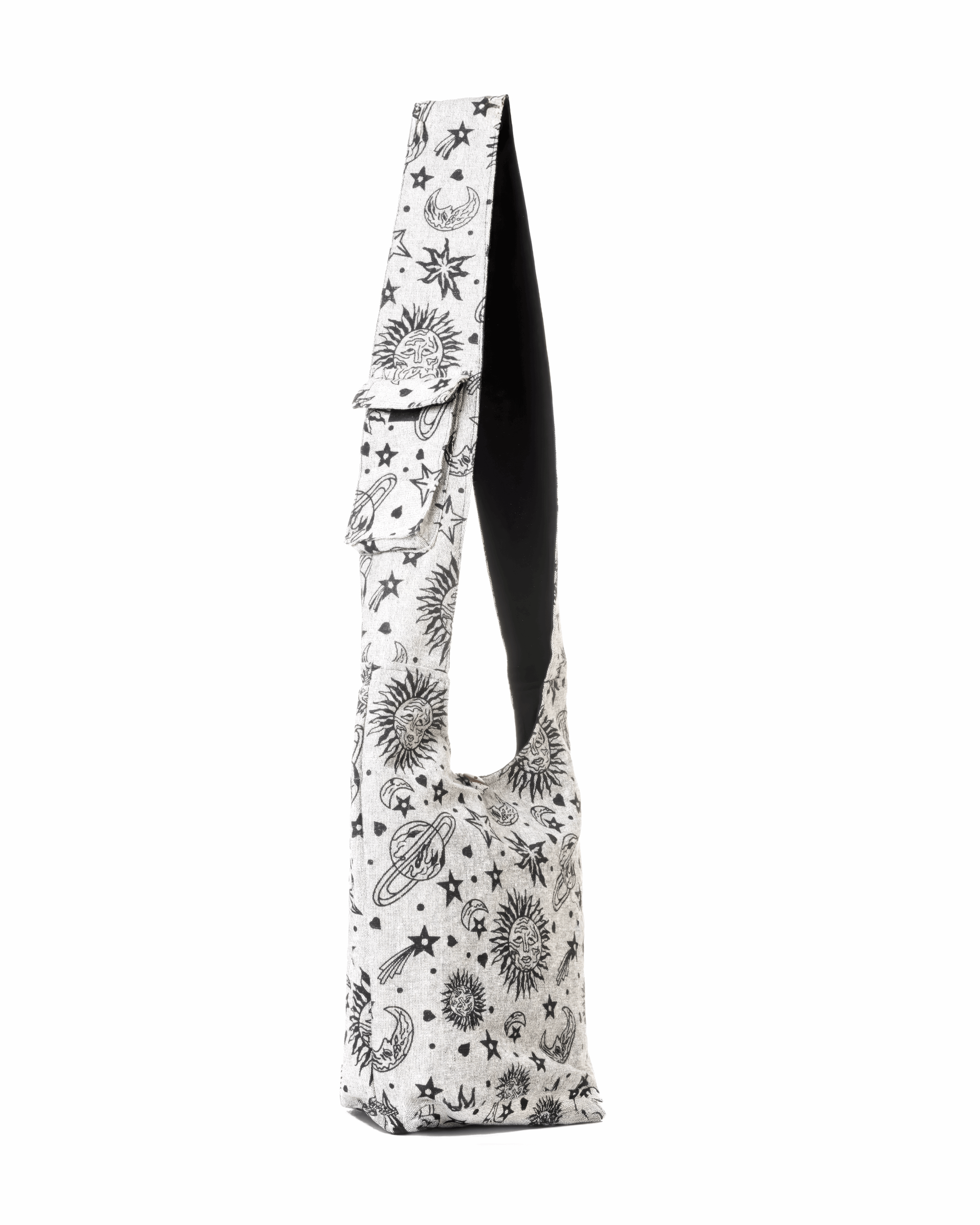 Beige sling bag with a cosmic print of stars, planets, and moons; black interior lining.