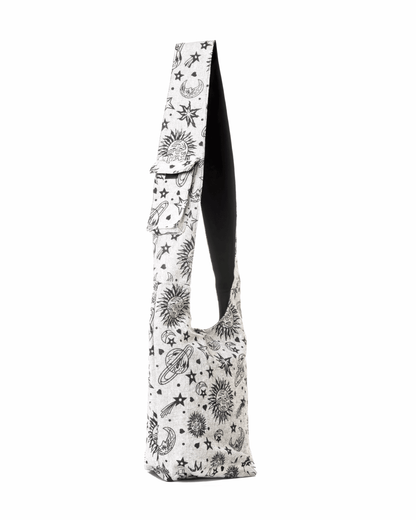 Beige sling bag with a cosmic print of stars, planets, and moons; black interior lining.