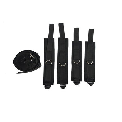 Black straps and coiled belt with metal clasps on white background.