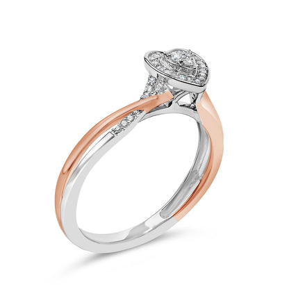 A heart-shaped diamond ring with rose gold and silver twisted band, featuring small side diamonds.