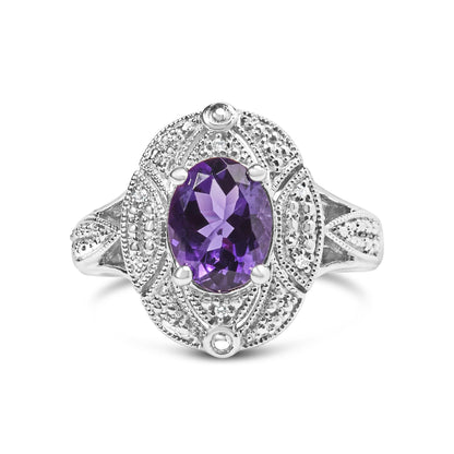 Silver ring with intricate patterns, featuring an oval purple gemstone at the center.