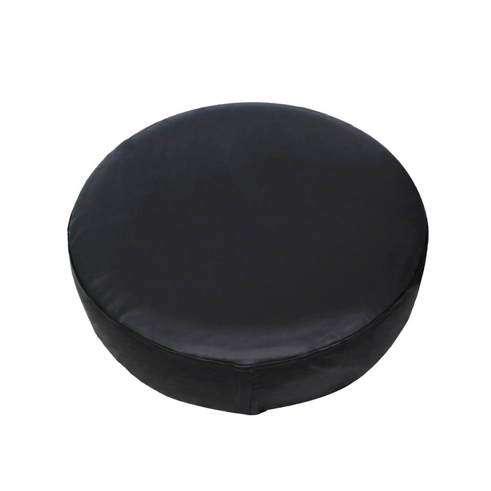 Black round cushion with smooth, leather-like texture on a white background.