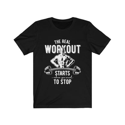 Black T-shirt with a muscular figure and dumbbells, text reads: "The real workout starts when you want to stop."