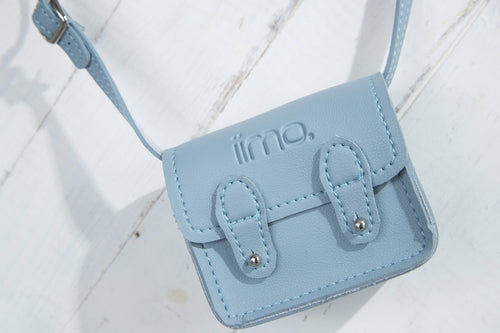Light blue mini satchel with embossed logo, two buckle straps, and silver hardware on a white background.