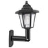 Black outdoor wall lantern with clear panels and hexagonal roof, mounted on a curved arm.