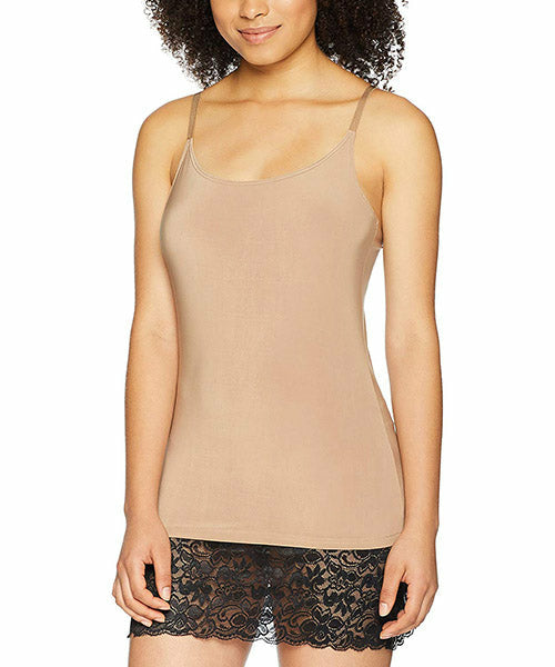 Woman in a beige camisole with thin straps and lace trim at the bottom, against a white background.