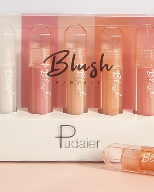 Five blush tubes in pink shades in a package, one tube out in front.