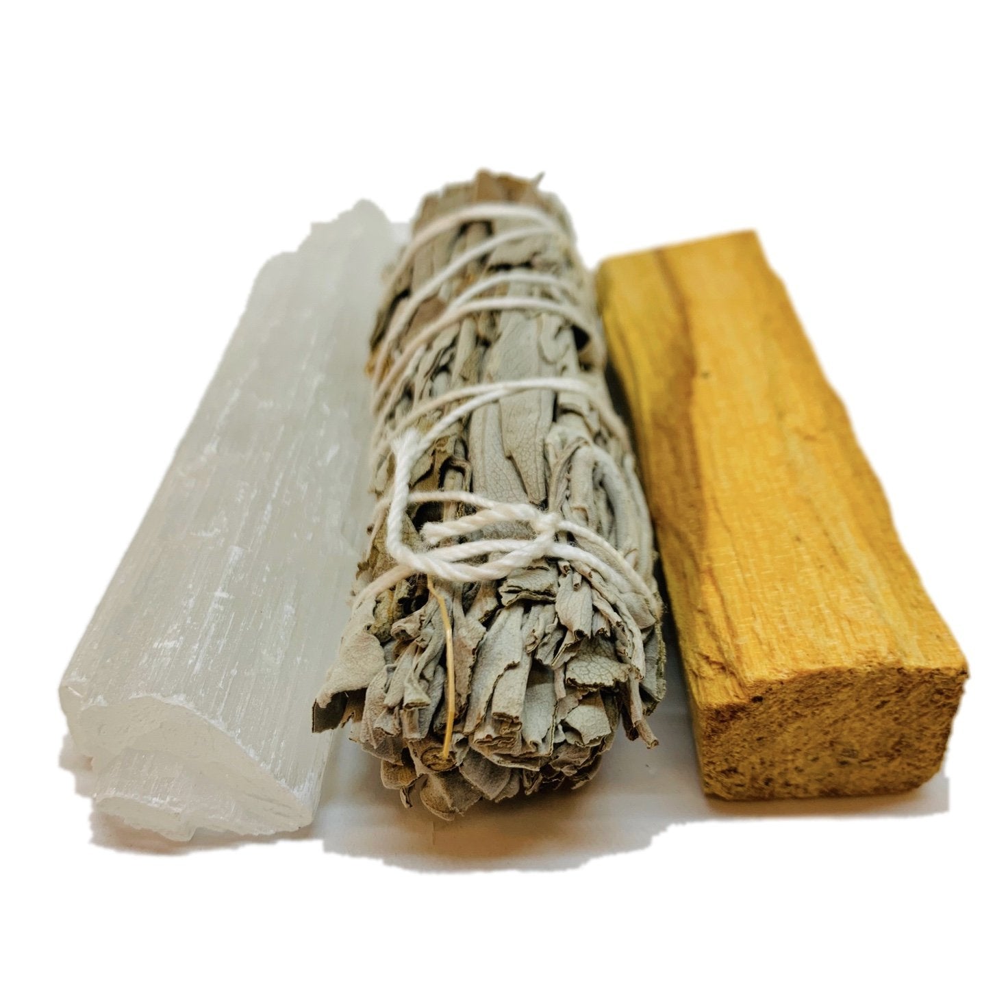 White selenite stick, bundled sage, and a pale brown palo santo stick on a white background.