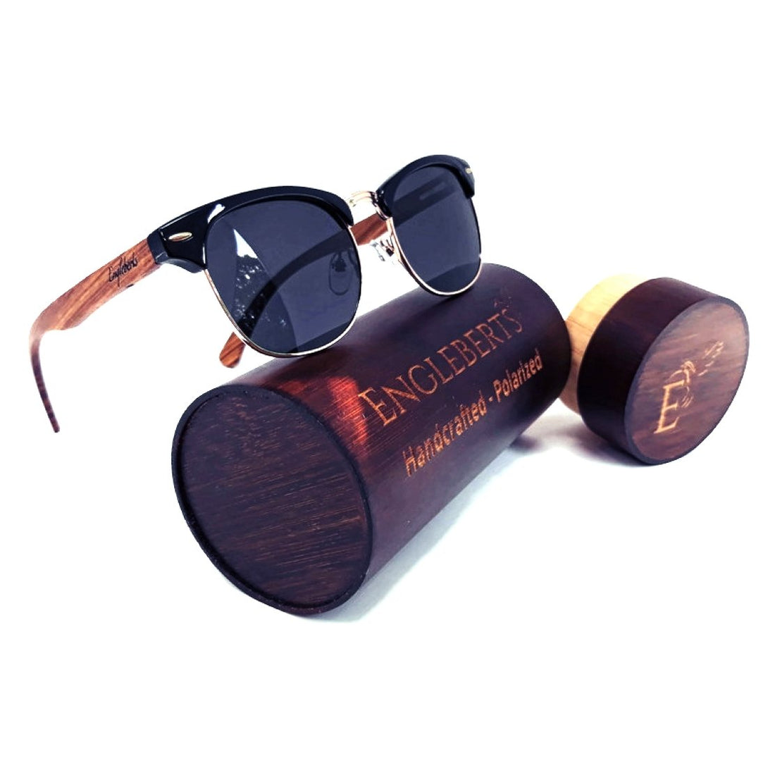Sunglasses with dark lenses, black frame, and wooden arms on a wooden Engleberts case.
