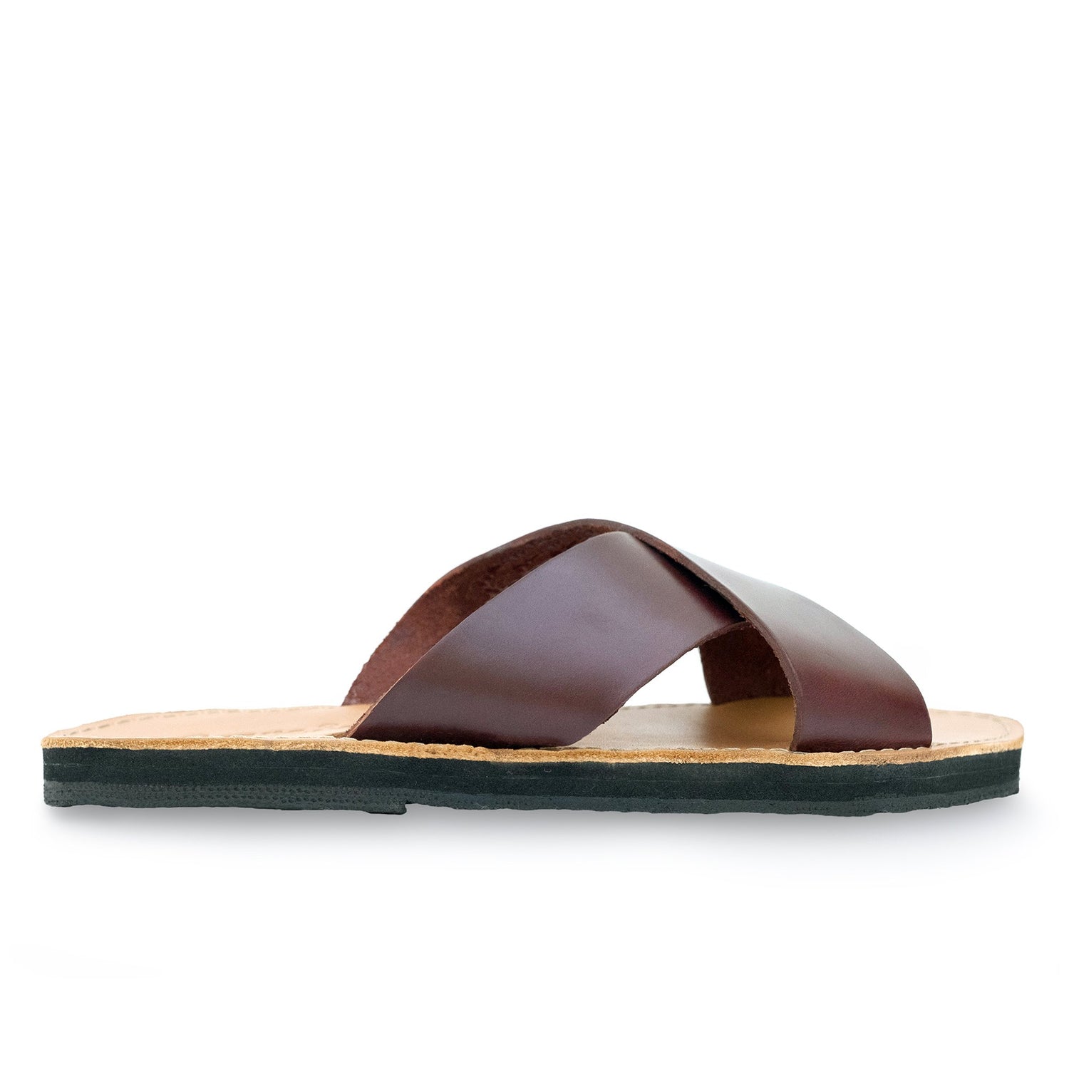 Brown leather sandal with crisscross straps, tan sole, and black bottom on a white background.