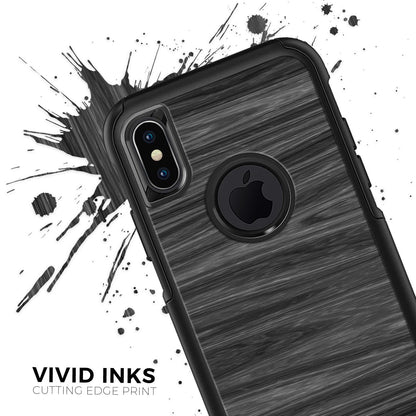 Black phone case with wood grain texture, dual camera cutout, and logo circle on ink-splatter background.